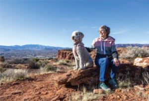 Senior Woman hiking with her dog