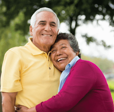 Diverse Elderly Couple Smiling and Hugging