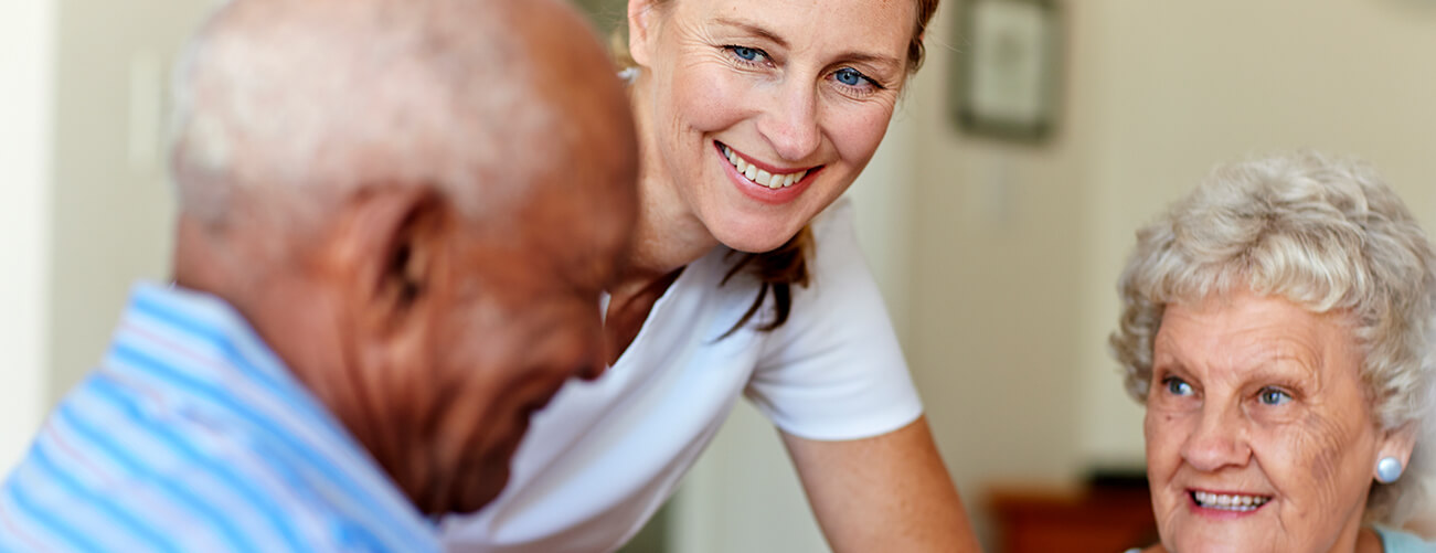 staff member helping a senior couple